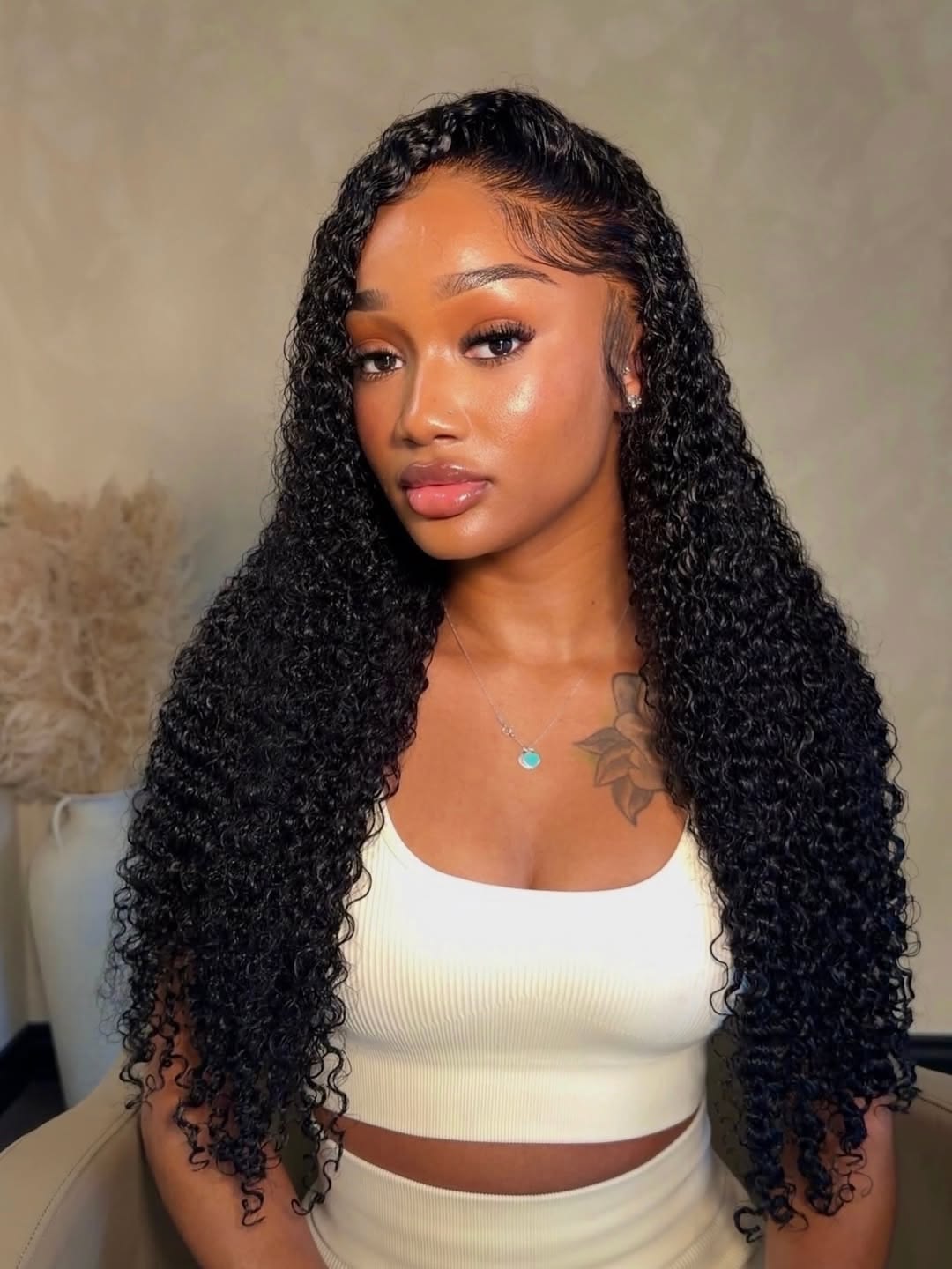Model with long voluminous deep curly black hair