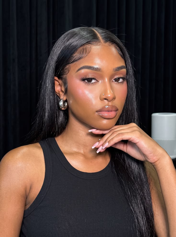 Model wearing a long sleek straight black wig